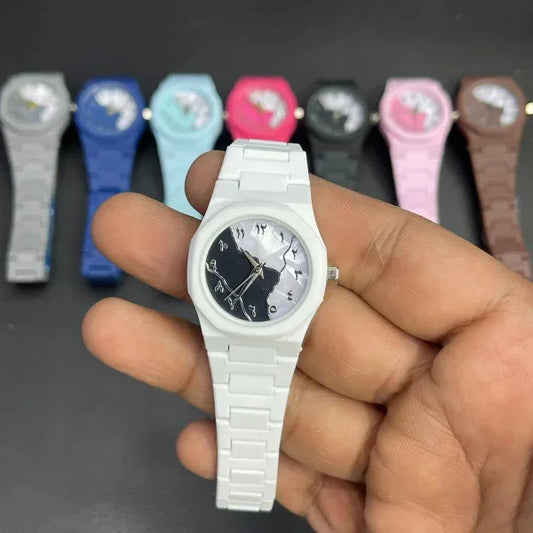 Hand holding a silver watch with other colorful watches in the background